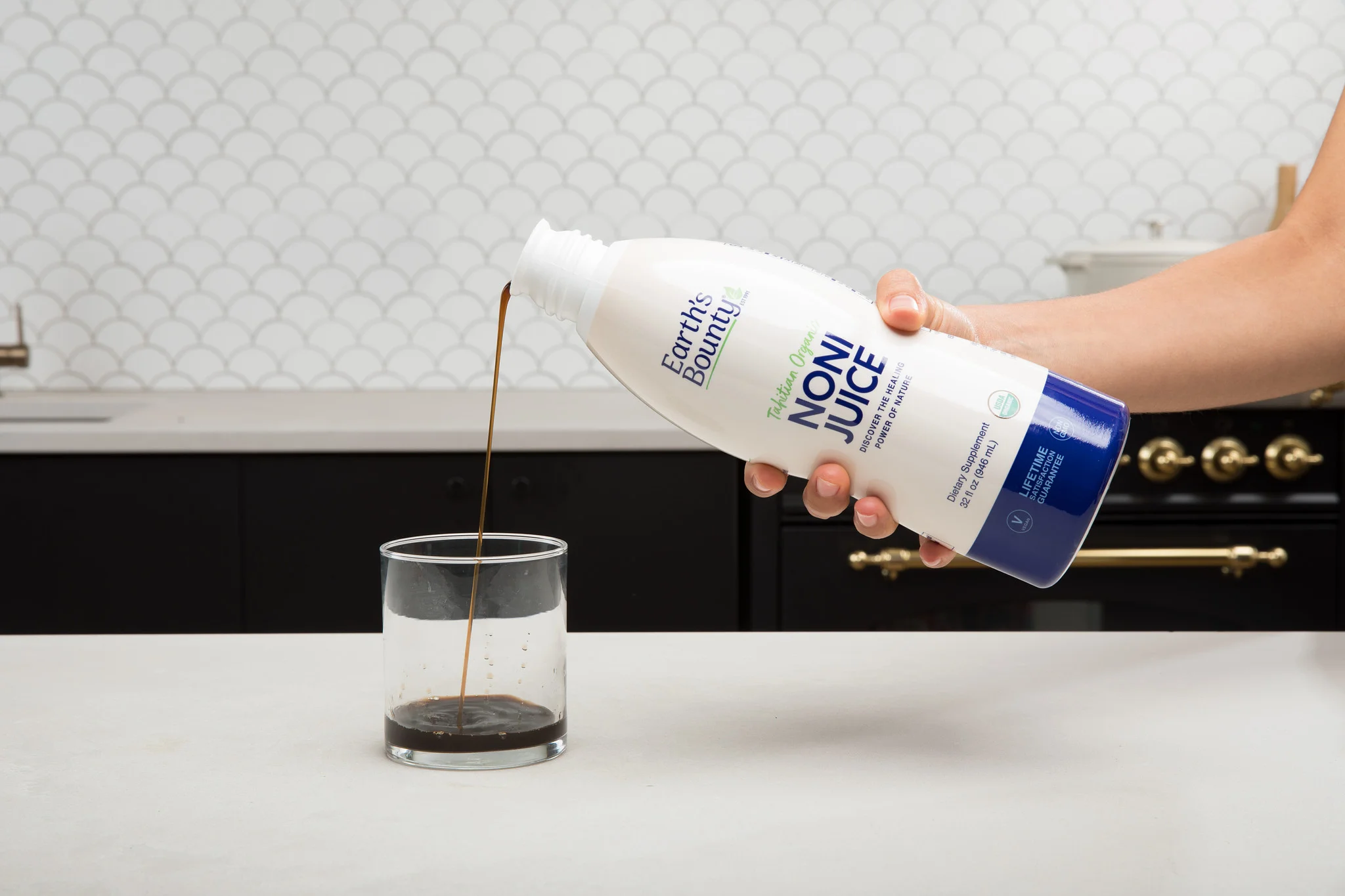 earths bounty noni juice being poured into glass